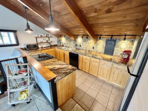 a large kitchen with wooden cabinets and a counter top at Mountain Home Getaway-great VIEWS & exercise room in Pocatello