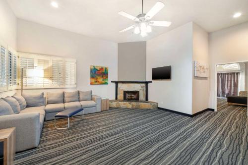 a living room with a couch and a fireplace at Best Western Posada Royale Hotel & Suites in Simi Valley