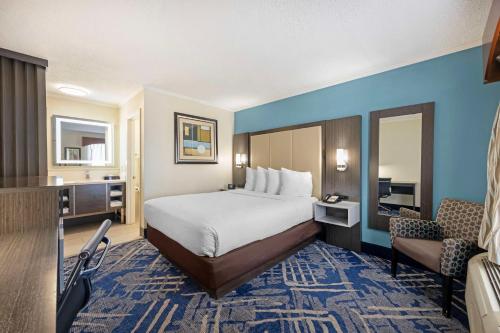 a large hotel room with a bed and a chair at Best Western Franklin in Franklin