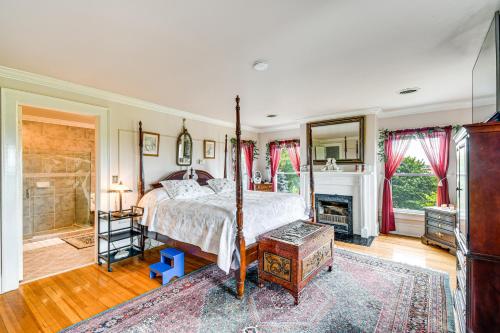 una camera da letto con un letto e un camino di Geneva Vacation Rental with Vineyard and Lake Views! a Geneva