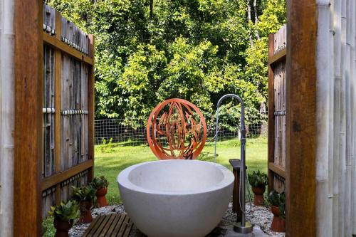 a bath tub on a patio with a fence at Pine Mountain - luxury rural estate with pool in Binna Burra