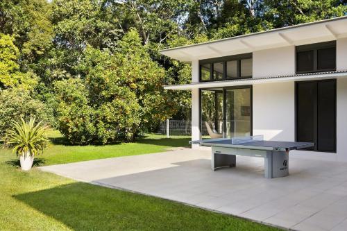 a ping pong table in front of a house at Pine Mountain - luxury rural estate with pool in Binna Burra
