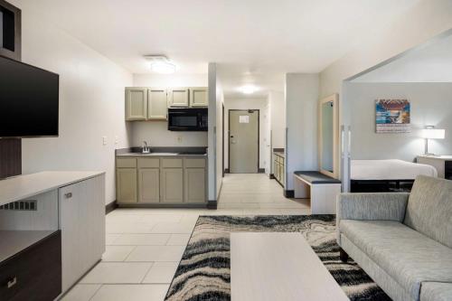 a living room with a couch and a kitchen at Best Western Morton Inn in Morton