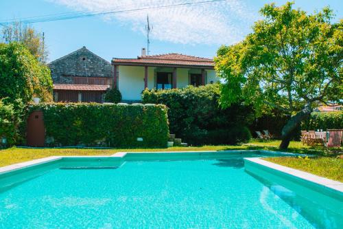 a swimming pool in the yard of a house at Just Like Home - Casa do Cruzeiro in Moledo