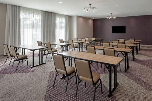 a conference room with tables and chairs and a flat screen tv at Residence Inn by Marriott Chatsworth in Chatsworth