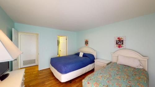 a bedroom with two beds and a desk at Heron Marsh Escape Split Level Villa Lake Views in Pawleys Island