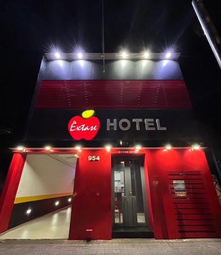 a red hotel with a sign on the side of it at Hotel Extase in Sao Paulo