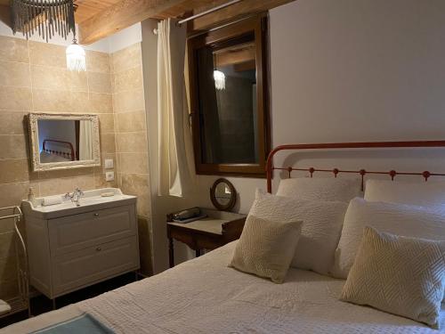 a bedroom with a bed and a sink and a mirror at Le chêne magique 40200 Margaux in Pontenx-les-Forges