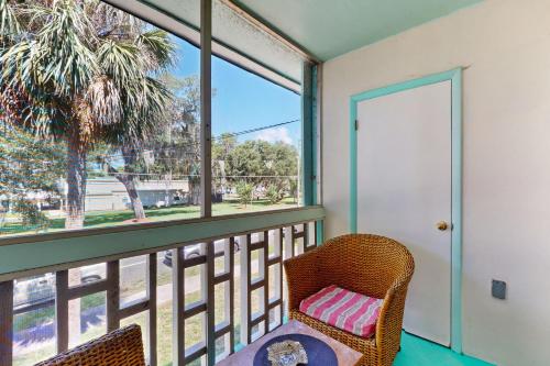 a balcony with a table and chairs and a window at Pendleton in Eustis