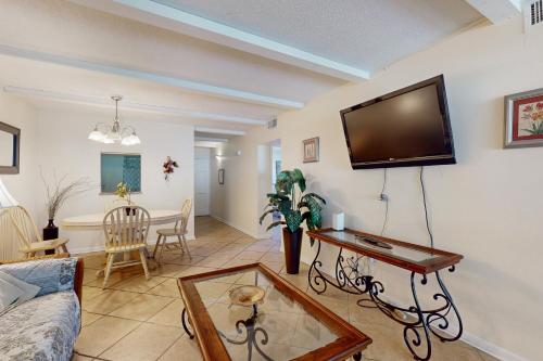 a living room with a flat screen tv on the wall at Pendleton in Eustis