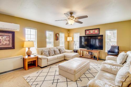a living room with couches and a flat screen tv at Mountain-View Cabin in Pinetop with Fire Pit and Yard in Pinetop-Lakeside