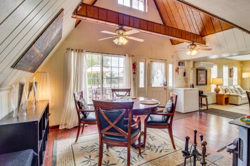 a kitchen and living room with a table and chairs at Mountain-View Cabin in Pinetop with Fire Pit and Yard in Pinetop-Lakeside