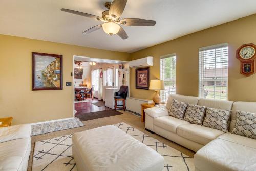 a living room with a couch and a ceiling fan at Mountain-View Cabin in Pinetop with Fire Pit and Yard in Pinetop-Lakeside