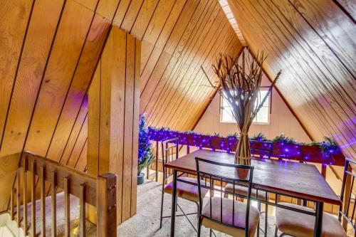 a room with a table with chairs and a vase of flowers at Mountain-View Cabin in Pinetop with Fire Pit and Yard in Pinetop-Lakeside