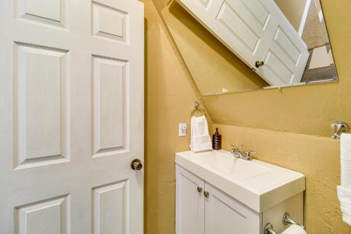 a bathroom with a white sink and a mirror at Mountain-View Cabin in Pinetop with Fire Pit and Yard in Pinetop-Lakeside