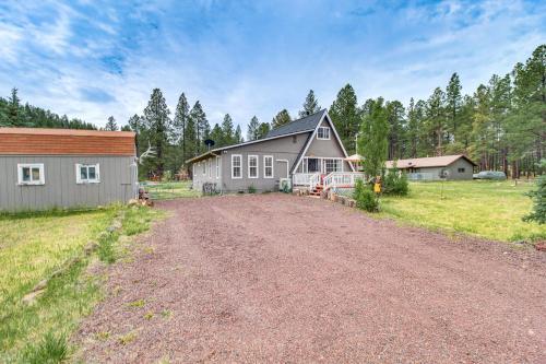 a dirt road in front of a house at Mountain-View Cabin in Pinetop with Fire Pit and Yard in Pinetop-Lakeside