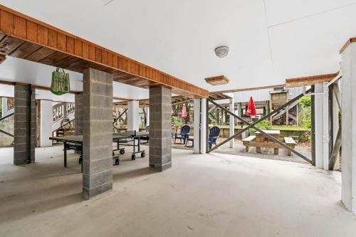 an empty room with tables and chairs in a building at CasaUp Charming Duplex in Beautiful Pawleys Island in Pawleys Island