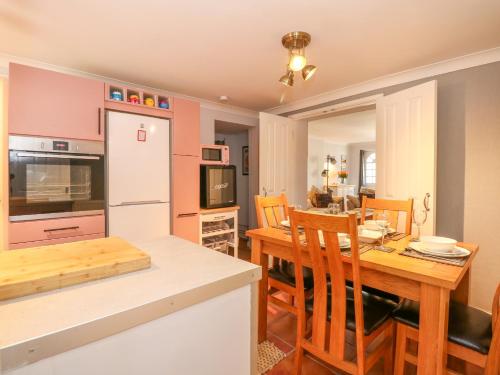 a kitchen and dining room with a table and chairs at Happy Daze in Cromer