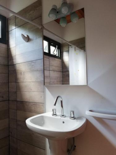a bathroom with a sink and a mirror at Cabaña Coyam in Villa del Dique