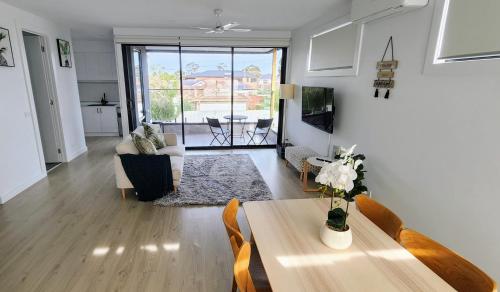 a living room with a table and a couch at Balcony At Sunshine Mellow Retreat 12 in Sunshine