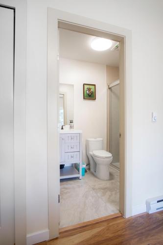 a bathroom with a toilet and a sink at Oceanfront Getaway in Sooke