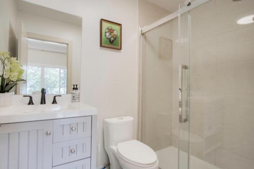 a bathroom with a shower and a toilet and a sink at Oceanfront Getaway in Sooke