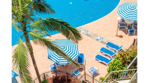 an overhead view of a pool with chairs and umbrellas at The Rocks 9J in Gold Coast