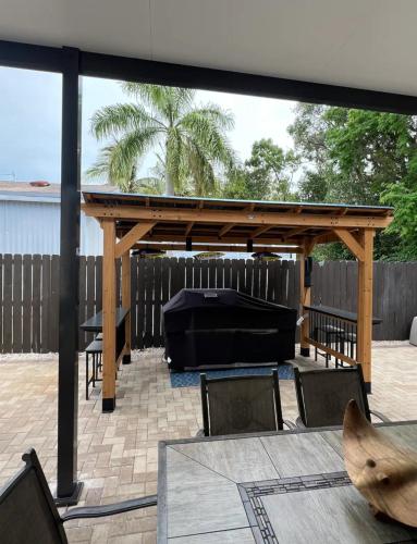 a wooden pergola with a table and chairs on a patio at Paradise key largo in Key Largo