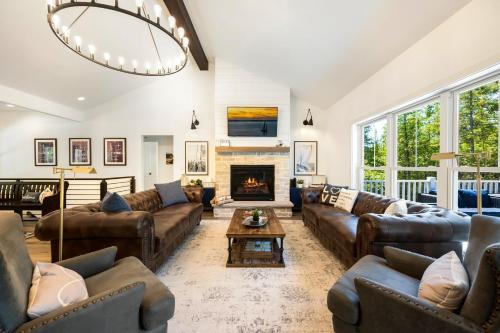 a living room with leather couches and a fireplace at The Ephraim House in Ephraim