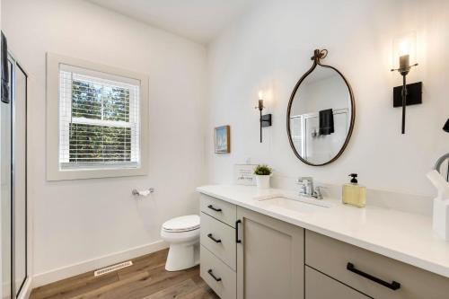 a white bathroom with a toilet and a mirror at The Ephraim House in Ephraim