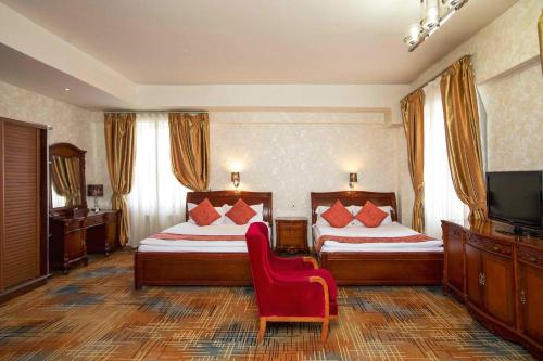 Postel nebo postele na pokoji v ubytování UB City Hotel