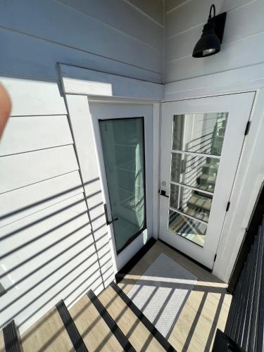 a screened in porch with a door and a window at Modern Bright New Studio with Roof-top Deck Walk to Santa Monica Beach, FreeWiFi, Parking in Santa Monica