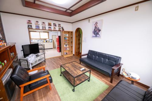 a living room with a couch and a coffee table at Tomoeドットコム3 music stay in Hakodate
