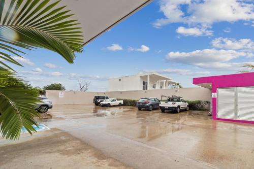 a parking lot with cars parked in front of a building at Hotel Yeah Rincón de Guayabitos in Rincon de Guayabitos