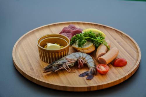 a plate of food with a lobster and other foods at Setouchi Island Stays Suo Oshima in Suo Oshima