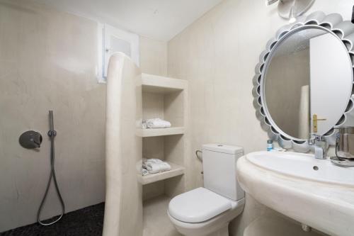 a bathroom with a toilet and a sink and a mirror at Studio Kocis in Monolithos