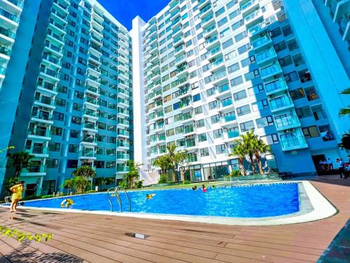 a swimming pool in front of two tall buildings at Homestay Huế ơi 2 in Thôn Văn Dương