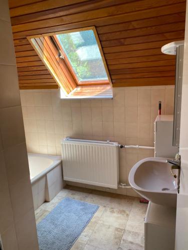 a bathroom with a window and a sink and a bath tub at Luxury 3 BR Vila in a forest 10min drive from city center in Budapest