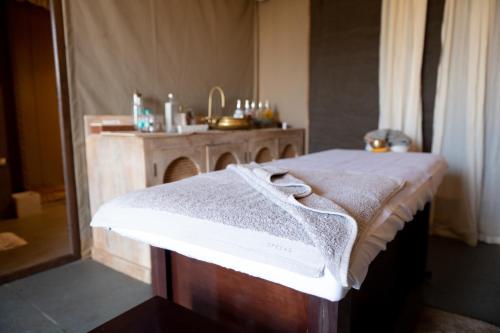 a bathroom with a table with a towel on it at Sangam Farms in Bhilwara