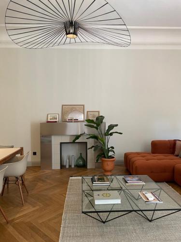 a living room with a couch and a table at Le Jardin des Etudes - Terrasse - Mansion 300 years in Avignon