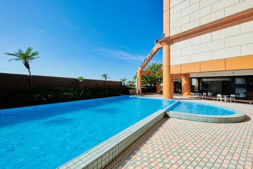 a swimming pool in front of a building at Boyokaku in Amakusa