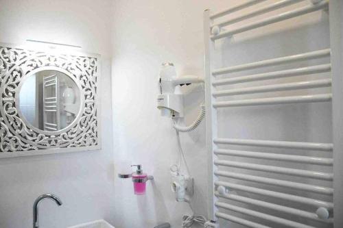 a white bathroom with a mirror and a sink at X C Apartamentos Morales & Arnal in Ronda
