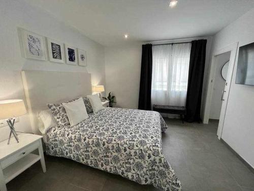 En eller flere senge i et værelse på XIX C Apartamentos Morales & Arnal