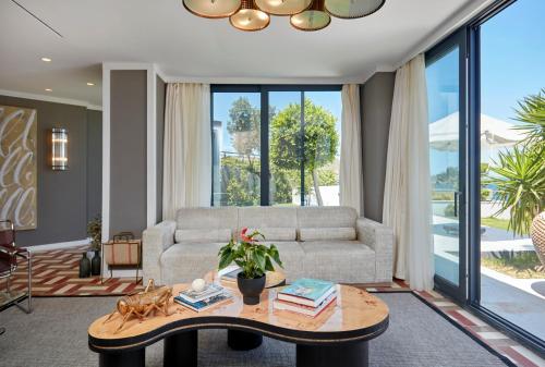 a living room with a couch and a table at Root Redrock Yalıkavak in Yalıkavak