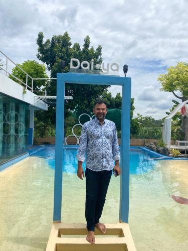 a man standing on a platform in front of a pool at Daiya Pool Villa, Khaoyai in Ban Sathani Phut Rai