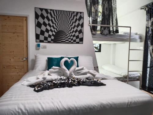 a bed with two swan towels on top of it at Daiya Pool Villa, Khaoyai in Ban Sathani Phut Rai