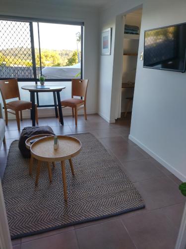 a living room with a table and chairs at Cosy, self-contained and central to everywhere in Gold Coast
