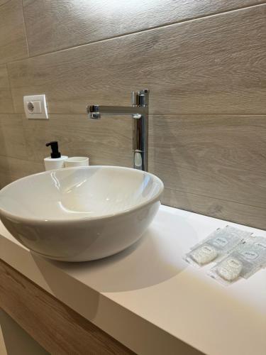 a white sink on a counter in a bathroom at Pescoluse Apartments in Marina di Pescoluse