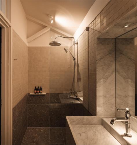 a bathroom with a shower and a sink at Noordin Mews in George Town