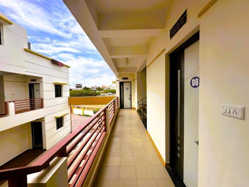 a corridor of a building with a balcony at Ranjan Vadi in Bhuj
